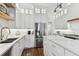 Bright kitchen with white cabinets, marble countertops and stainless steel appliances at 3311 Home Ct, Tampa, FL 33611