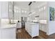 Modern kitchen featuring white cabinetry, marble countertops, stainless steel appliances, and a center island at 3311 Home Ct, Tampa, FL 33611