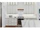 Clean kitchen showcasing white cabinetry, marble backsplash, and stainless steel gas range at 3311 Home Ct, Tampa, FL 33611