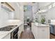 Open kitchen with marble countertops, stainless steel oven, and view into the living room at 3311 Home Ct, Tampa, FL 33611