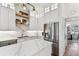 Modern kitchen featuring white cabinetry, stainless steel refrigerator, and marble countertops at 3311 Home Ct, Tampa, FL 33611