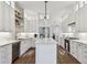 Bright kitchen with white cabinets, island, quartz counters and stainless-steel appliances at 3311 Home Ct, Tampa, FL 33611