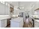 Modern kitchen with white cabinets, island, quartz counters and stainless-steel appliances at 3311 Home Ct, Tampa, FL 33611