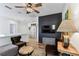 Stylish upstairs living area featuring hardwood floors, a dark accent wall, and neutral decor at 3311 Home Ct, Tampa, FL 33611
