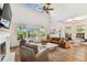 Bright living room with vaulted ceilings, fireplace, and views of a lush, landscaped exterior at 3311 Home Ct, Tampa, FL 33611