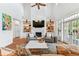 Bright living room features vaulted ceilings, fireplace with TV, and French doors to the exterior at 3311 Home Ct, Tampa, FL 33611