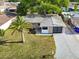Aerial view of the home showcasing the well-kept yard, landscaping, and overall property layout at 3338 Hoover Dr, Holiday, FL 34691