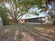 Expansive backyard features mature trees, a sun room, and plenty of space for outdoor activities at 3338 Hoover Dr, Holiday, FL 34691