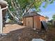 View of a backyard shed surrounded by lush trees, offering storage and functionality at 3338 Hoover Dr, Holiday, FL 34691