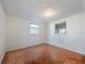 Well-lit bedroom with parquet floors and bright natural light with windows on two walls at 3338 Hoover Dr, Holiday, FL 34691
