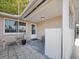 Cozy front porch area with outdoor seating and a view of the front yard at 3338 Hoover Dr, Holiday, FL 34691