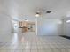 Bright and airy living room featuring tile flooring and an open layout to the kitchen and front entry at 3338 Hoover Dr, Holiday, FL 34691