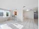 Bright and airy living room with tile floors, a window, and an open bar area at 3338 Hoover Dr, Holiday, FL 34691