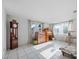 Bright living room with tile flooring, a grandfather clock, and natural light at 3338 Hoover Dr, Holiday, FL 34691