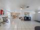 Open living space with kitchen, tile floors, bright natural light, and neutral walls at 3338 Hoover Dr, Holiday, FL 34691