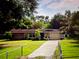Charming home featuring a quaint front yard and an attached garage with driveway at 33640 Brisk Dr, Wesley Chapel, FL 33543