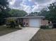Inviting single-story home with a well-kept front yard and a convenient attached garage at 33640 Brisk Dr, Wesley Chapel, FL 33543