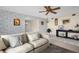 A cozy living room offers stylish wallpaper, wood floors, modern furniture, and a ceiling fan at 3815 35Th S Way # 102, St Petersburg, FL 33711
