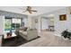 Bright living room with neutral tones, stylish furnishings, and sliding glass doors to outdoor space at 3815 35Th S Way # 102, St Petersburg, FL 33711