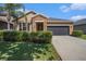 Charming single-Gathering home featuring desert landscaping, a two-car garage, and a stone-accented entryway at 4145 Shrewbury Pl, Land O Lakes, FL 34638