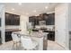 Modern kitchen boasts black cabinets, granite countertops, stainless steel appliances, and a center island at 4145 Shrewbury Pl, Land O Lakes, FL 34638