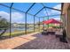 Relaxing screened patio with brick pavers, overlooking a tranquil pond view, and comfortable seating at 4145 Shrewbury Pl, Land O Lakes, FL 34638