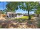 Backyard showcasing a screened porch and fenced yard, creating a private outdoor oasis for relaxation and entertainment at 4220 Oakfield Ave, Holiday, FL 34691