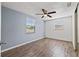 Inviting bedroom with wood-look floors, a ceiling fan, and natural light streaming through the windows, creating a serene atmosphere at 4220 Oakfield Ave, Holiday, FL 34691