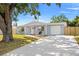 Charming single story home with a well-manicured lawn, driveway, and garage at 4220 Oakfield Ave, Holiday, FL 34691
