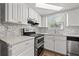 Bright kitchen features stainless steel appliances, stylish backsplash, and a double oven at 4220 Oakfield Ave, Holiday, FL 34691