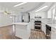 Bright kitchen featuring stainless steel appliances, granite countertops, and a stylish island for food preparation and dining at 4220 Oakfield Ave, Holiday, FL 34691