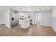 Modern kitchen features a center island, stainless steel appliances, and white cabinets at 4220 Oakfield Ave, Holiday, FL 34691