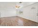 Bright and airy living room features hardwood floors and a front door with a decorative window at 4220 Oakfield Ave, Holiday, FL 34691