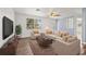 Bright living room with hardwood floors, neutral-toned furniture, a large window, and modern decor at 4220 Oakfield Ave, Holiday, FL 34691