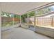 Enjoy outdoor living on this screened patio, offering a shaded area with views of the fenced backyard at 4220 Oakfield Ave, Holiday, FL 34691