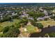 The property is adjacent to a golf course with ponds and lush landscapes surrounded by community homes at 4240 Golf Club Ln, Tampa, FL 33618