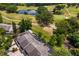 Aerial view of home near golf course, pond, and green landscape, offering a scenic residential location at 4240 Golf Club Ln, Tampa, FL 33618