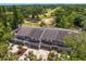 Aerial view of townhomes near golf course, mature trees, and manicured lawns at 4240 Golf Club Ln, Tampa, FL 33618