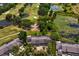 Aerial view of the home near golf course, pond, and verdant landscaping, emphasizing a serene and recreational environment at 4240 Golf Club Ln, Tampa, FL 33618