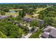 Scenic aerial view of townhomes surrounded by golf course, pond, and mature trees at 4240 Golf Club Ln, Tampa, FL 33618