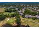Scenic aerial shot highlighting the home's location near a golf course, a pond with lily pads, and mature trees at 4240 Golf Club Ln, Tampa, FL 33618
