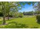 Picturesque backyard view with lush green grass and a tranquil pond at 4240 Golf Club Ln, Tampa, FL 33618