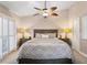 Large bedroom with a decorative ceiling fan and a large window at 4240 Golf Club Ln, Tampa, FL 33618