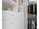 Walk-in closet with custom shelving and drawers, offering plenty of storage space at 4240 Golf Club Ln, Tampa, FL 33618
