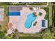 Aerial view of the community pool with lounge chairs, covered patio, and lush landscaping in a tranquil setting at 4240 Golf Club Ln, Tampa, FL 33618