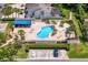 Aerial view of the renovated community pool and lounge area, showcasing palm trees, outdoor furniture, and well-kept landscaping at 4240 Golf Club Ln, Tampa, FL 33618