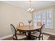 Classic dining room with a wood table, upholstered chairs, and bright natural light at 4240 Golf Club Ln, Tampa, FL 33618