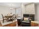 Comfortable dining area with a fireplace, cozy chair and an oval dining table at 4240 Golf Club Ln, Tampa, FL 33618
