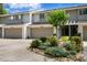 Charming townhome featuring a well-maintained exterior, landscape, and attached garages at 4240 Golf Club Ln, Tampa, FL 33618