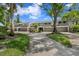 View of the front exteriors of the townhomes with a driveway and sidewalks at 4240 Golf Club Ln, Tampa, FL 33618